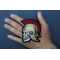 Roman Skull Soldier Patch shown on hand for size comparison
