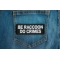 Be Raccoon Do Crimes Patch shown on jeans