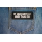 My Back Goes Out More Than I Do Patch shown on jeans