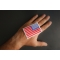 White Border Reversed American Flag Patch shown on hand for size comparison