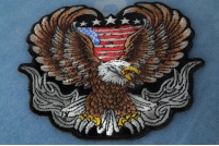 Up-winged biker eagle, with a portion of the American flag behind it