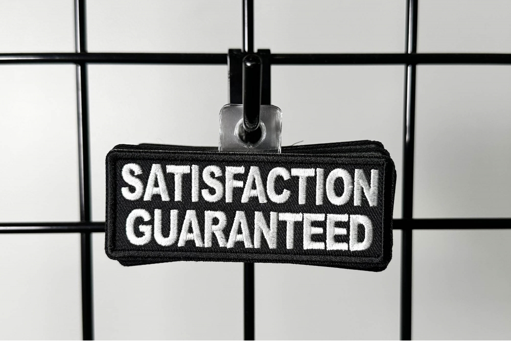 Peel and Stick Plastic Hanging Hooks shown on hand for size comparison