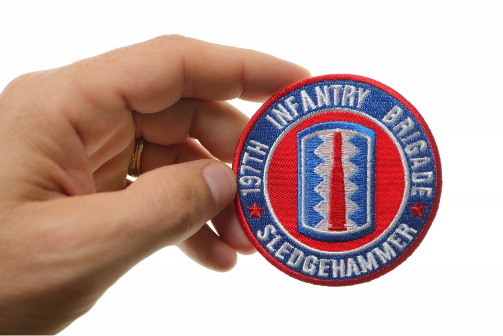 197th Infantry Brigade Iron on Patch Sledgehammer shown on hand for size comparison