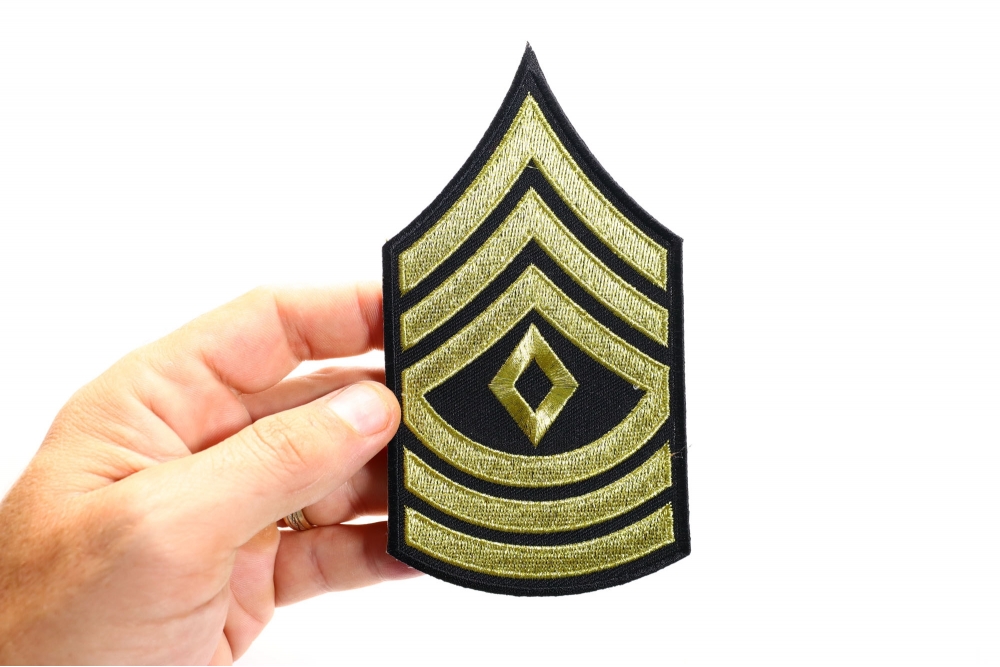 First Sergeant Iron on Patch shown on hand for size comparison