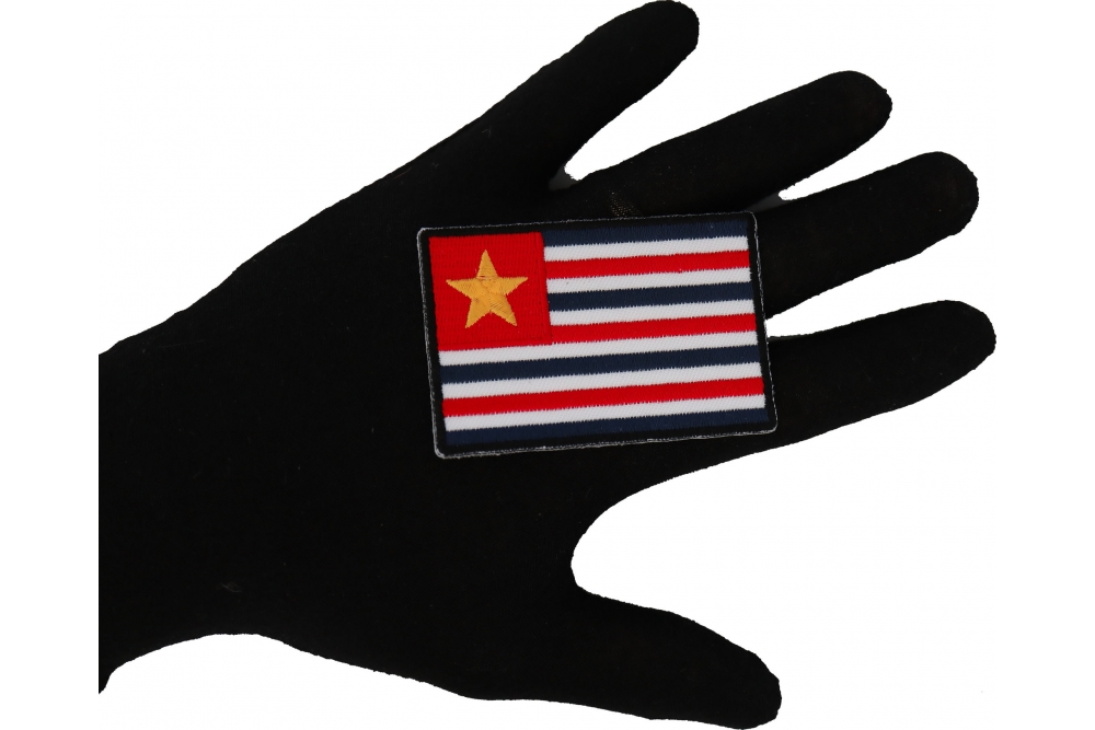 Historical Louisiana Flag Iron on Patch shown on hand for size comparison