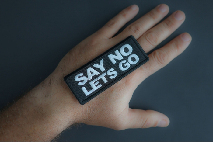 Say No Lets Go Patch shown on hand for size comparison