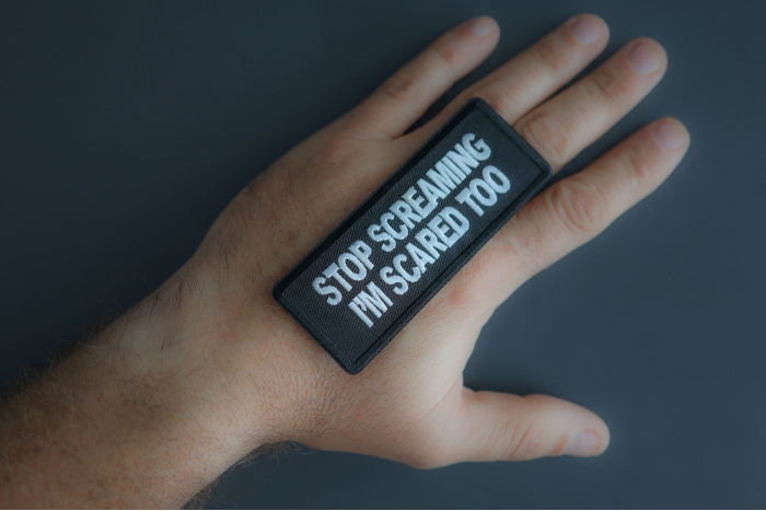 Stop Screaming I'm Scared Too Patch shown on hand for size comparison