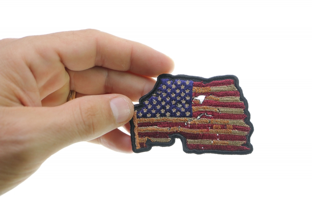 Vintage American Flag Patch shown on hand for size comparison