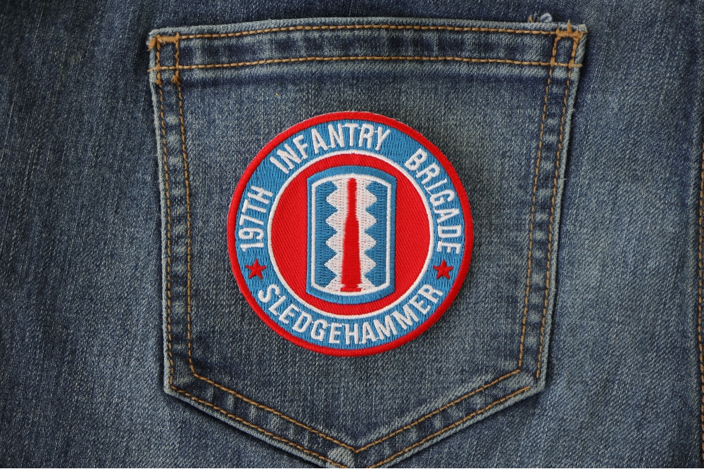 197th Infantry Brigade Iron on Patch Sledgehammer shown on jeans