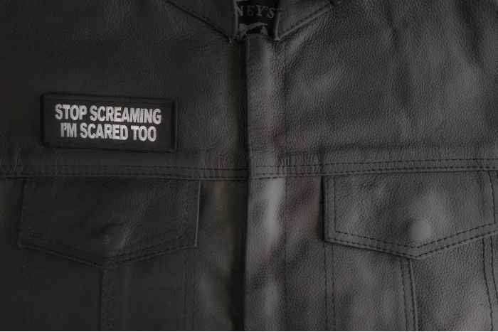 Stop Screaming I'm Scared Too Patch shown on leather vest