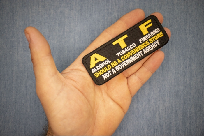 ATF, Alcohol Tobacco Firearms, Should Be A Convenience Store, Not a Government Agency Patch shown on hand for size comparison