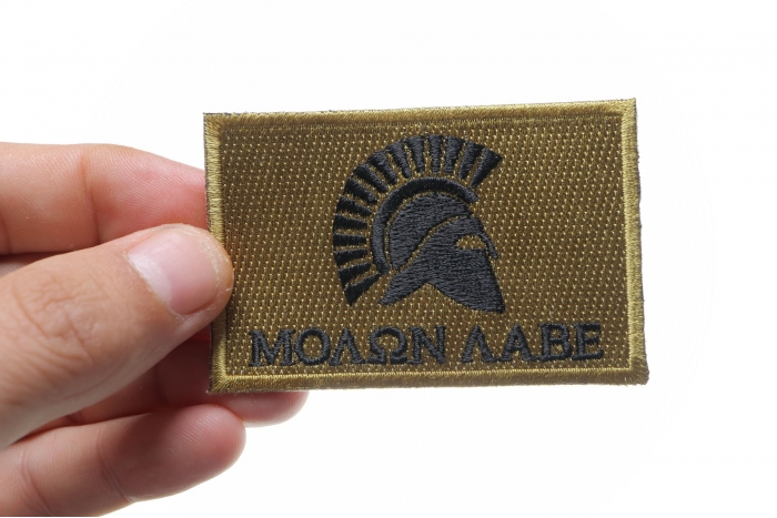 Black and Brown Come and Take It Molon Labe Spartan Helmet Patch shown on hand for size comparison