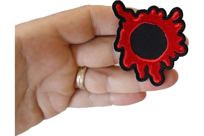 Bullet Hole Patch Blood Red shown on hand for size comparison