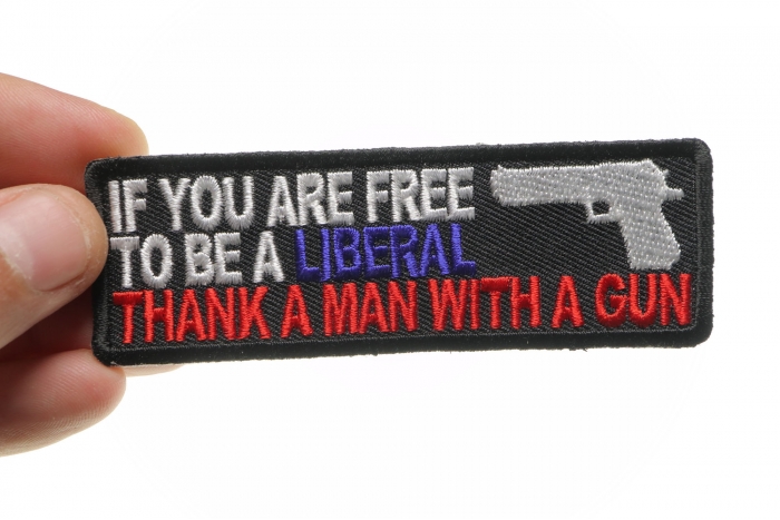 If You Are Free To Be Liberal Thank A Man With A Gun Patch shown on hand for size comparison