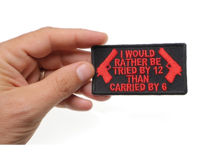 I Would Rather Be Tried By 12 Than Carried By 6 Patch In Red shown on hand for size comparison