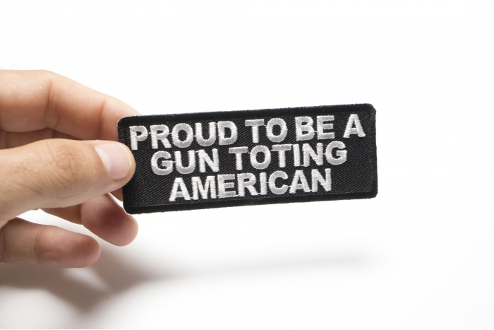 Proud To Be A Gun Toting American Patch shown on hand for size comparison