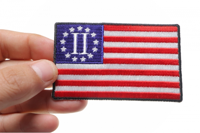 Second American Revolution Flag Patch shown on hand for size comparison
