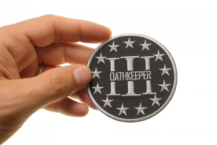 Three Percenter Oathkeeper Round Patch Gray shown on hand for size comparison