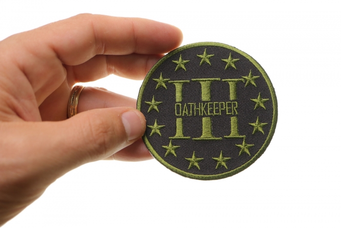 Three Percenter Oathkeeper Round Patch Green shown on hand for size comparison