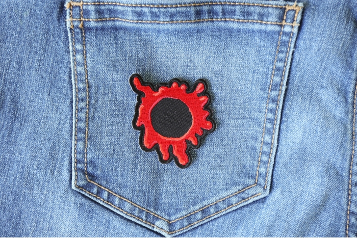 Bullet Hole Patch Blood Red shown on jeans