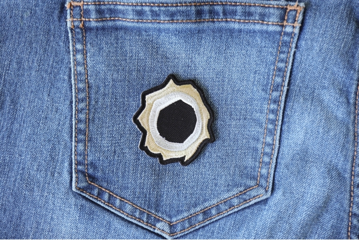 Bullet Hole Patch Green Metal shown on jeans