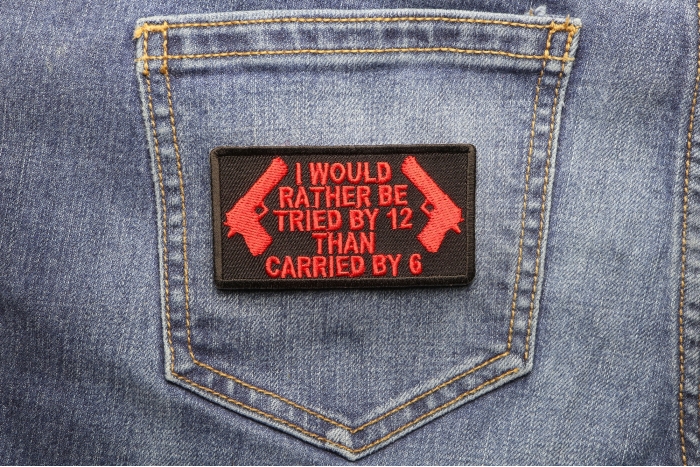 I Would Rather Be Tried By 12 Than Carried By 6 Patch In Red shown on jeans