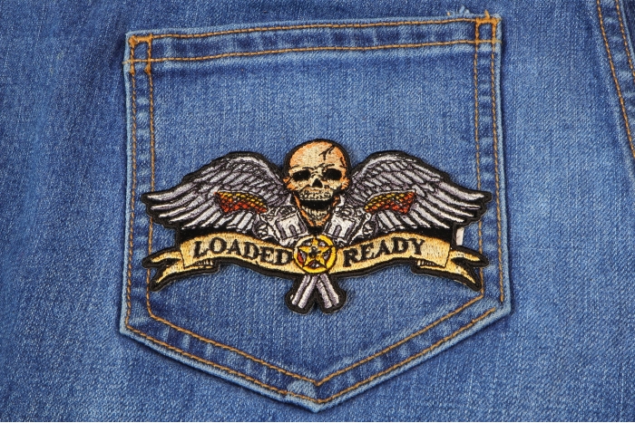 Loaded and Ready Skull Wings Pistols Patch shown on jeans
