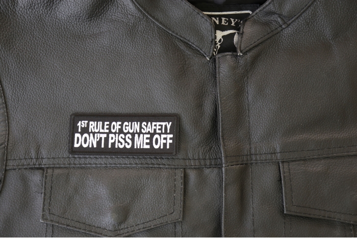 1st Rule of Gun Safety Don't Piss Me Off Patch - 4x1.5 inch - Embroidered Iron on Patch shown on leather vest
