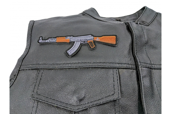 AK 47 Patch - 6x2 inch. Embroidered Iron on Patch shown on leather vest
