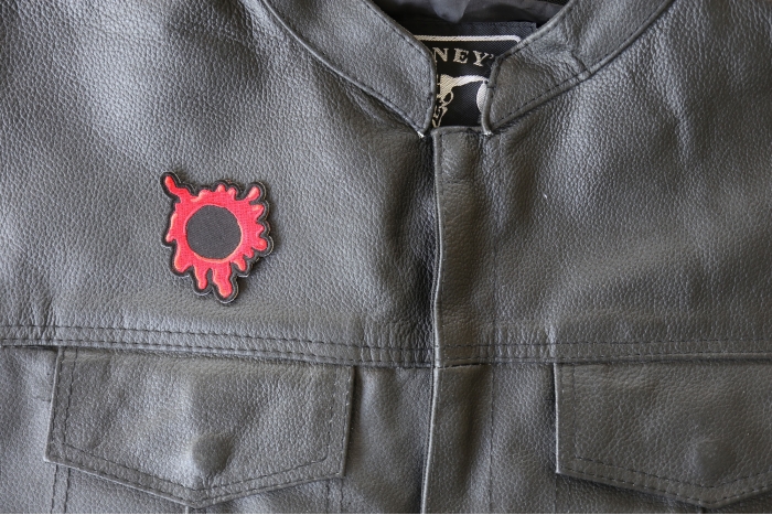 Bullet Hole Patch Blood Red - 2x2.4 inch - Embroidered Iron on Patch shown on leather vest