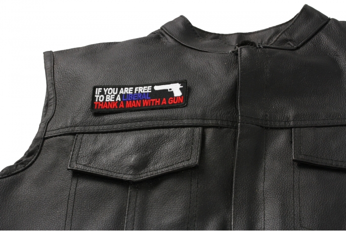If You Are Free To Be Liberal Thank A Man With A Gun Patch - 4x1.25 inch. Embroidered Iron on Patch shown on leather vest