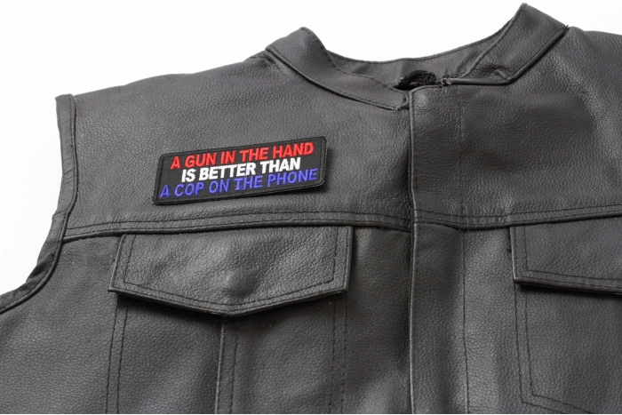 Gun In Hand Better is Better Than Cop On Phone Patch - 4x1.75 inch. Embroidered Iron on Patch shown on leather vest