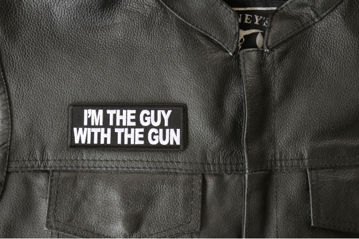 I'm The Guy with the Gun Patch, Funny Saying Patches, Sew or Iron on Patch shown on leather vest