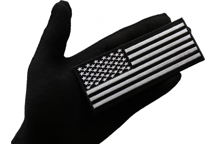 American Flag Patch Black White 5 inch shown on hand for size comparison