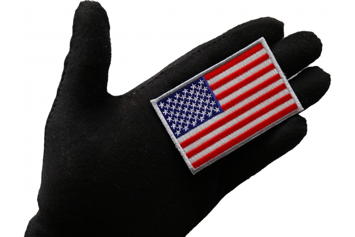 American Flag Patch Silver Border shown on hand for size comparison