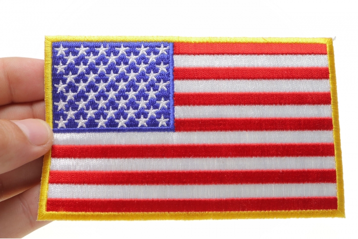 American Flag Patch with Yellow Borders shown on hand for size comparison