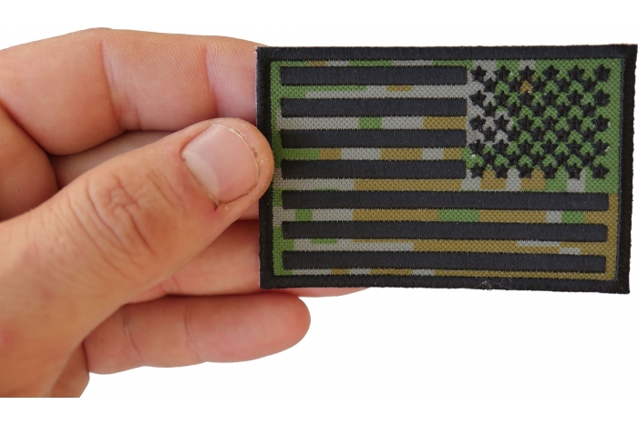 American Flag Reversed Camo Patch shown on hand for size comparison