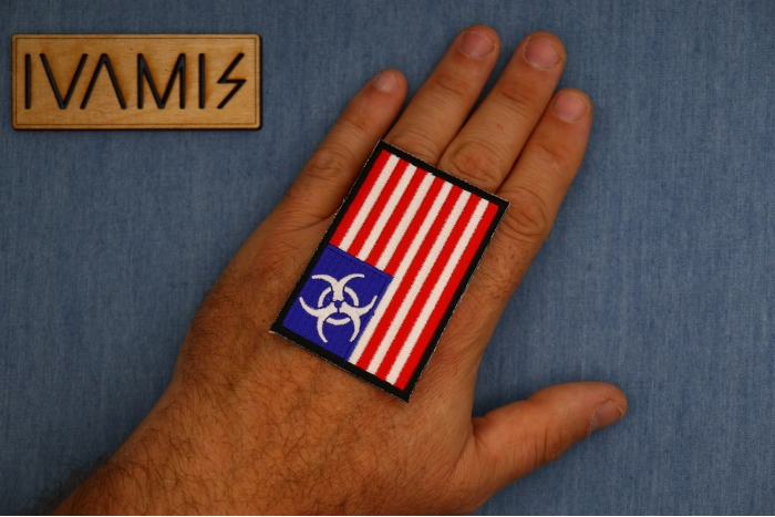 Biohazard US Flag Patch shown on hand for size comparison