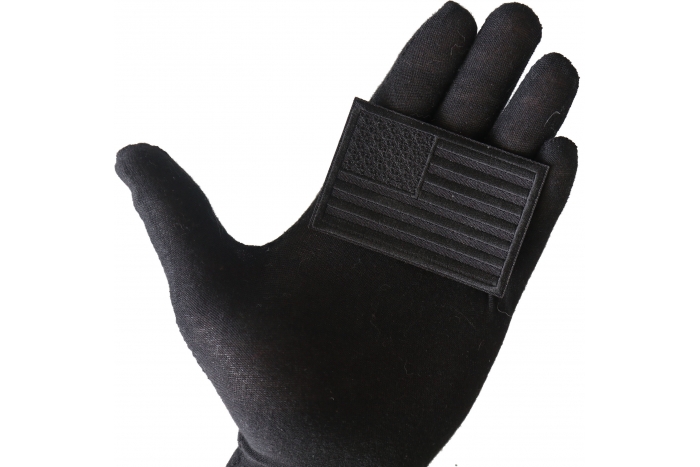 Black American Flag Patch shown on hand for size comparison