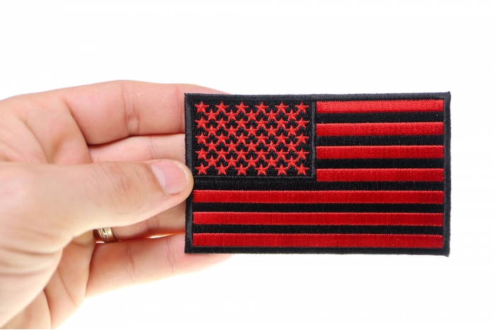 Black and Red American Flag Patch 4 Inch shown on hand for size comparison