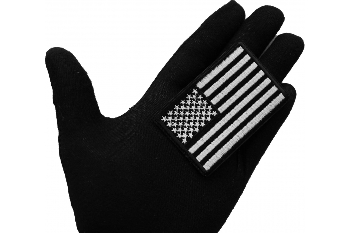 Black and White American Flag Patch shown on hand for size comparison