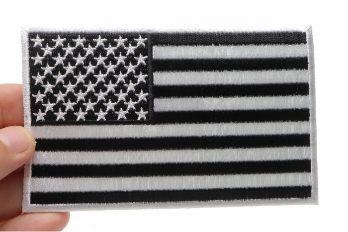 Black and White American Flag Patch with White Borders shown on hand for size comparison