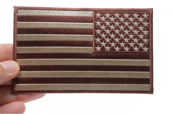 Brown Subdued American REVERSED Flag Patch shown on hand for size comparison
