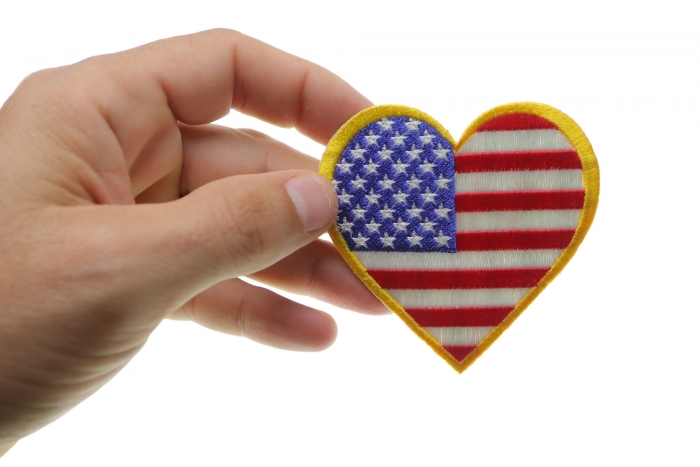 Gold Border Love US Flag Heart Patch shown on hand for size comparison