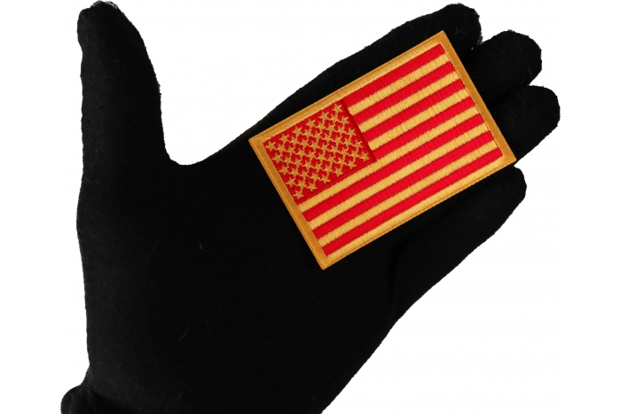 Red and Yellow US Flag Patch shown on hand for size comparison