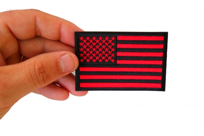 Red Black American Flag Patch shown on hand for size comparison