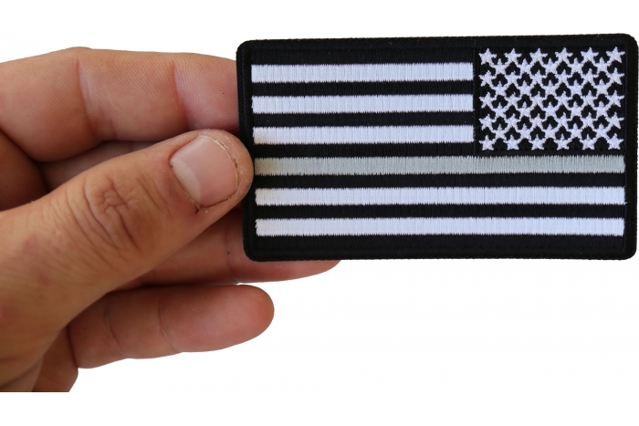 Reversed Silver Line Corrections Officer American Flag Patch shown on hand for size comparison