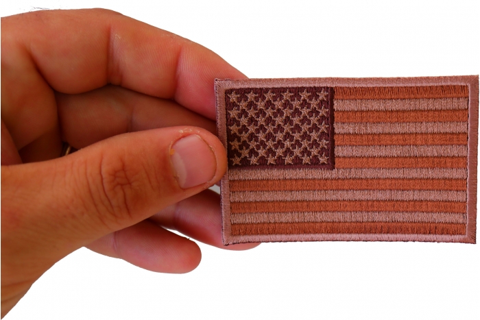 Subdued Brown US Flag Patch shown on hand for size comparison