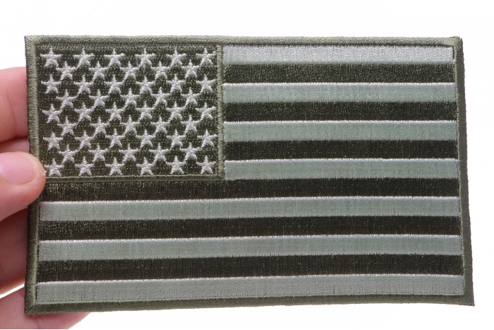 Subdued Green American Flag Patch shown on hand for size comparison