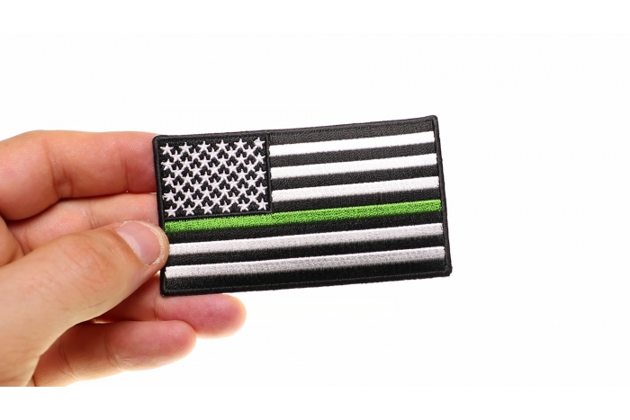Subdued Green Stripe American Flag Patch shown on hand for size comparison
